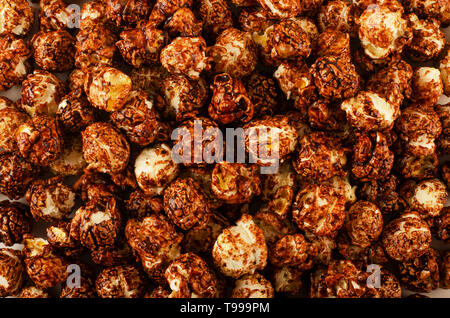 Scattered chocolate popcorn texture background Stock Photo