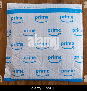 A white padded envelope showing a blue Amazon 'Prime' logo. Stock Photo