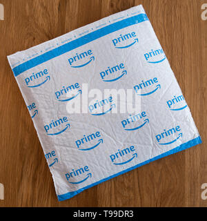 A white padded envelope showing a blue Amazon 'Prime' logo. Stock Photo