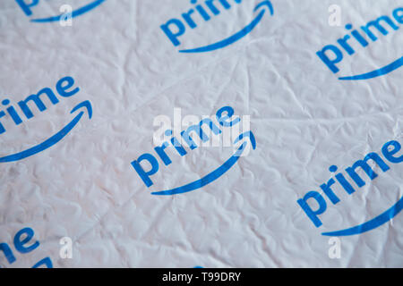 A white padded envelope showing a blue Amazon 'Prime' logo. Stock Photo