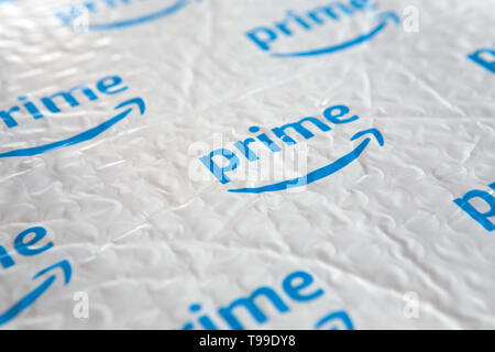 A white padded envelope showing a blue Amazon 'Prime' logo. Stock Photo