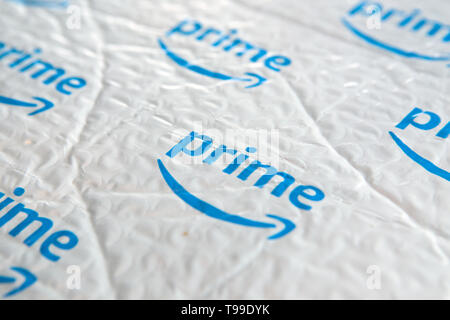 A white padded envelope showing a blue Amazon 'Prime' logo. Stock Photo