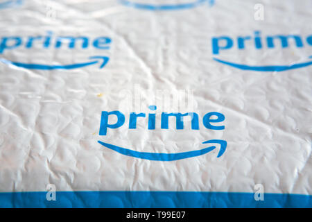 A white padded envelope showing a blue Amazon 'Prime' logo. Stock Photo