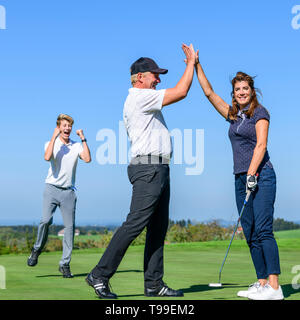 Give me five after perfect putt Stock Photo