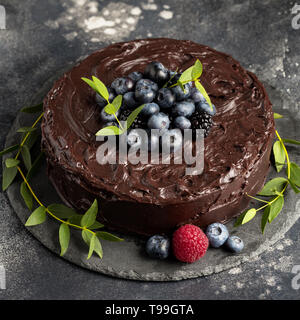 Cake with chocolate and berries on dark background Stock Photo