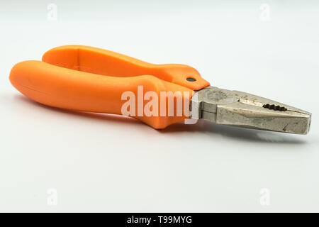 This is a capture of an orange diagonal pliers with a white background and a studio light Stock Photo