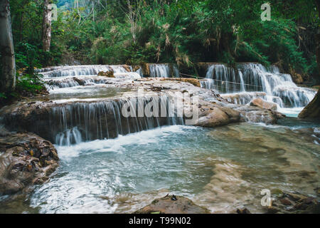 Deep forest waterfall at Erawan waterfall National Park. long exposure. Beautiful scenery. Waterfall in the wild jungle. Asian nature. Cascade of smal Stock Photo