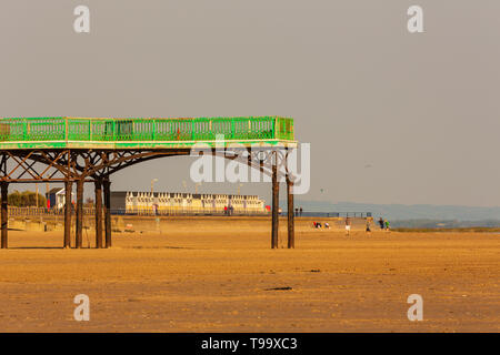 the beach at st annes on sea in the evening sunshine the pier with the st annes beach huts in the background Stock Photo