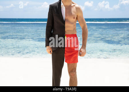 Portrait Of A Man In Formalwear And Shorts Standing In Front Of Sea At Beach Stock Photo