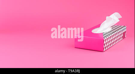 paper napkins in a pink box on a plain background. Free space for text. Copy space Stock Photo