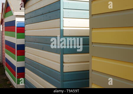 Colourful striped wooden beach huts at Budleigh Salterton, Devon, England Stock Photo