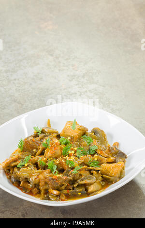 Stew of pork and vegetables served in a white porcelain dish Stock Photo