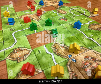Turin, Piedmont, Italy. May 2019. Strategy board game, set inspired by the medieval town of Carcassonne in France. The players move around the field t Stock Photo