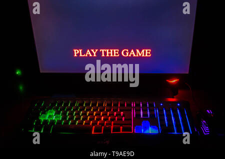 illuminated mea mechanical computer keyboard at nigh and hands waitingto start play the game. Stock Photo