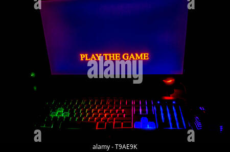 illuminated mea mechanical computer keyboard at nigh and hands waitingto start play the game. Stock Photo