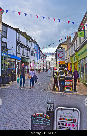 A street view of Fore Street in Brixham, bedecked with bunting in celebration of the Pirates' Festival taking place over the weekend. Stock Photo