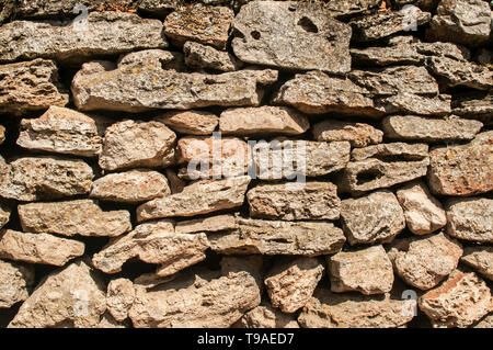 Old rural dry masonry stone wall closeup as stone background Stock Photo