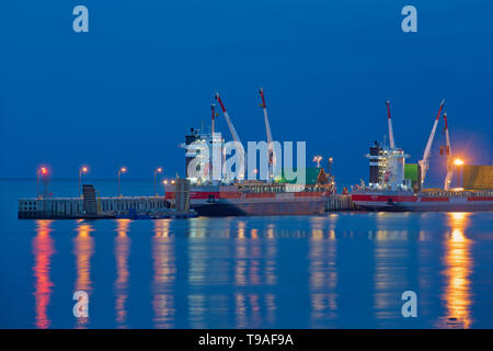 Reflections of ship at dock in the North Shore of the Gulf of St. Lawrence Baie Comeau Quebec Canada Stock Photo