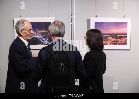 Berlin, Germany. 17th May, 2019. Visitors talk in front of pictures displayed during Nanjing Cultural and Tourism Weeks at the China Cultural Center in Berlin, capital of Germany, on May 17, 2019. Credit: Shan Yuqi/Xinhua/Alamy Live News Stock Photo