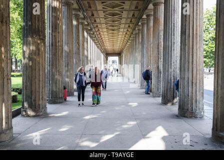 Beijing, Germany. 17th May, 2019. Pedestrians walk between pillars in front of the Alte Nationalgalerie (Old National Gallery) at Museum Island in Berlin, capital of Germany, on May 17, 2019. Museum Island, a UNESCO world heritage site, is the northern part of an island in the Spree river in Berlin. Its name comes from the complex of worldwide famous museums such as Altes Museum (Old Museum), Neues Museum (New Museum), Alte Nationalgalerie (Old National Gallery), Bode Museum and Pergamon Museum. May 18 marks the International Museum Day. Credit: Shan Yuqi/Xinhua/Alamy Live News Stock Photo