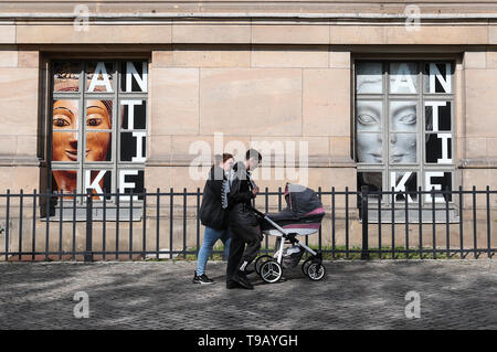 Beijing, Germany. 17th May, 2019. Pedestrians walk past two windows of the Altes Museum (Old Museum) at Museum Island in Berlin, capital of Germany, on May 17, 2019. Museum Island, a UNESCO world heritage site, is the northern part of an island in the Spree river in Berlin. Its name comes from the complex of worldwide famous museums such as Altes Museum (Old Museum), Neues Museum (New Museum), Alte Nationalgalerie (Old National Gallery), Bode Museum and Pergamon Museum. May 18 marks the International Museum Day. Credit: Shan Yuqi/Xinhua/Alamy Live News Stock Photo