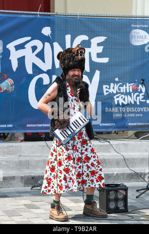 Brighton UK 18th May 2019 - A singing bear in a dress part of the 'Bear North' show at the Fringe City street entertainment which is part of the Brighton Festival 2019 . Credit : Simon Dack / Alamy Live News Stock Photo