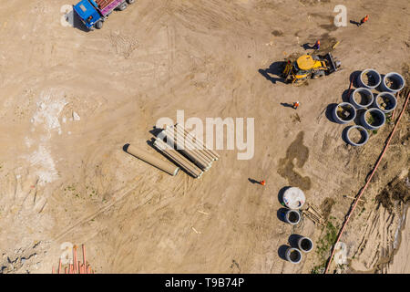 Industrial truck loader excavator moving earth and unloading. Aerial view Stock Photo