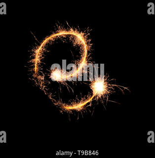 Sparklers forming letter E on dark background Stock Photo