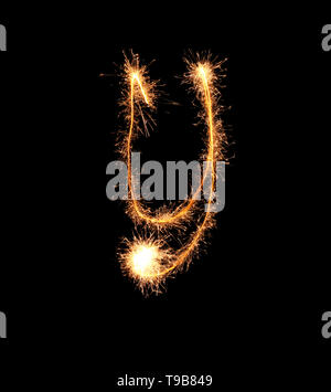 Sparklers forming letter Y on dark background Stock Photo