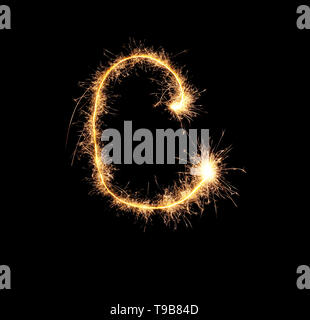Sparklers forming letter C on dark background Stock Photo