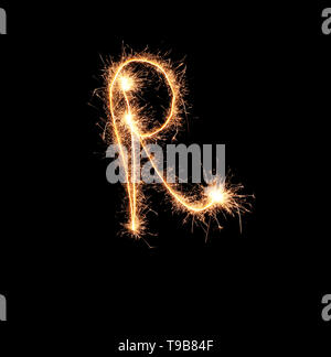 Sparklers forming letter R on dark background Stock Photo