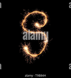 Sparklers forming letter S on dark background Stock Photo