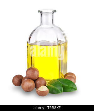 Macadamia oil in bottle and nuts Stock Photo