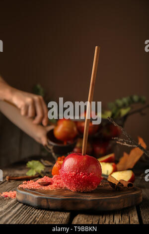 Red candy apple on wooden table Stock Photo