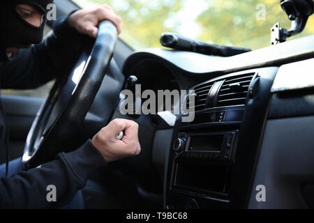 Male thief sitting in car Stock Photo