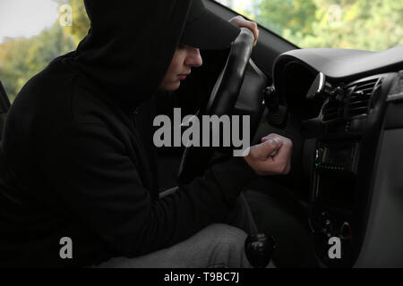 Male thief sitting in car Stock Photo