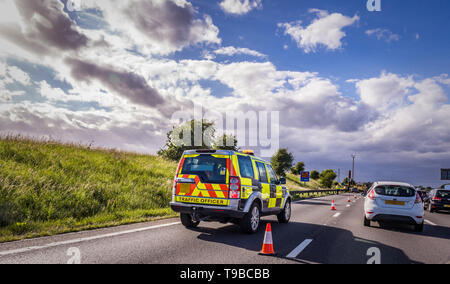 Traffic officer vehicle in closed off lane of motorway due to incident Stock Photo