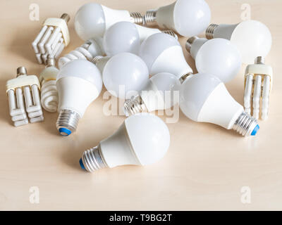 many various LED bulb lights and energy-saving lamps on table Stock Photo
