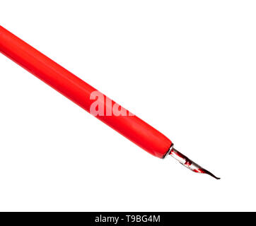 side view of red dip pen with pointed nib painted by red ink cut out on white background close up Stock Photo