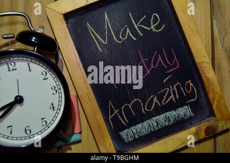 Make Today Amazing on phrase colorful handwritten on chalkboard and alarm clock with motivation, inspiration and education concepts. Table background Stock Photo