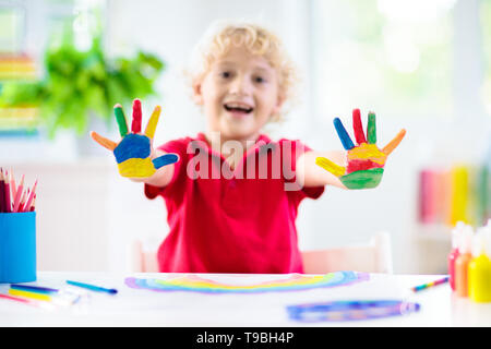 Kids Paint. Child Painting In White Sunny Study Room. Little Girl Drawing  Rainbow. School Kid Doing Art Homework. Arts And Crafts For Kids. Paint On  Children Hands. Creative Little Artist At Work.
