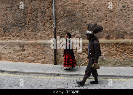 A Zarron seen walking on the streets during the festival in Almazan. El Zarron of Almazan Festival is a shepherd’s tradition just over 200 hundred years old that honours Saint Pascual Bailon. On its origins shepherds founded a Saint Pascual Bailon brotherhood and started parading a figure representing their Saint around the village. El Zarron is a character that represents the shepherds and wears beard, a hat with vulture feathers and a sheep or fox tail and leather clothes. Members of the brotherhood throw sweets ahead of the procession, and the Zarron has to clear the way of young people wit Stock Photo