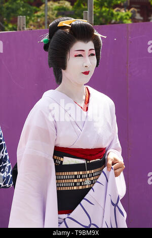 Woman dressed as geisha in traditional Japanese clothing (kimono, yukata) and white makeup, during procession at Sanja Matsuri Festival in Asakusa. Stock Photo