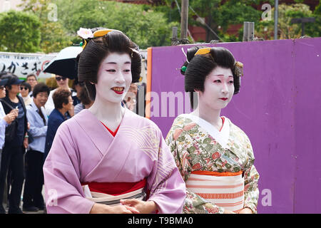 Women dressed as geisha in traditional Japanese clothing (kimono, yukata) and white makeup, during procession at Sanja Matsuri Festival in Asakusa. Stock Photo