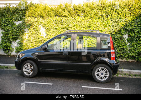 Strasbourg, France - May 19, 2017: Black family Fiat Italian car against green wall background Stock Photo
