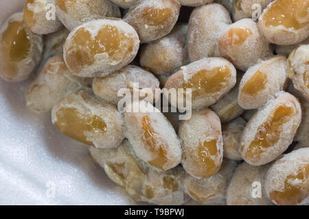 Natto - close up shot. Natto is a popular and healthy Japanese food made from fermented beans. Macro. Stock Photo