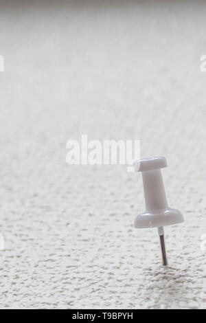 push pin pinned on a surface with copy space. Stock Photo