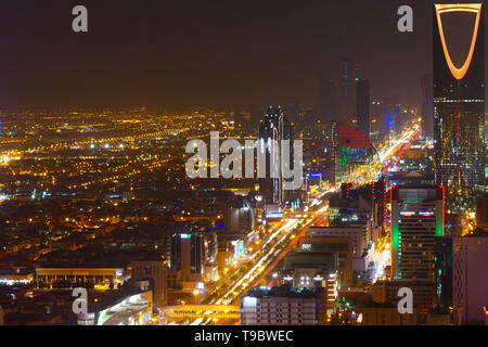 Panorama view to the skyline of Riyadh by night, with the Kingdom centre in the background and yellow lighting, the capital of Saudi Arabia Stock Photo