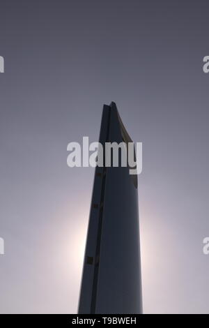 RIYADH, SAUDI ARABIA - DECEMBER 18, 2018: Side view of the Kingdom Centre by day with the sun in the background Stock Photo