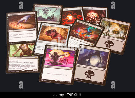 Cards of game Magic: The Gathering on black background. Magic can be played by two or more players in various rule formats. Stock Photo
